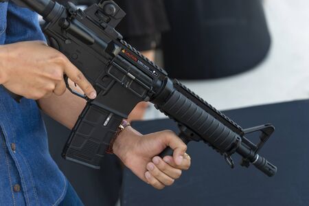 A man holding a gun in hand ready to shoot for self defense