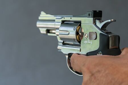 Man holding gun revolver pistol in shooting