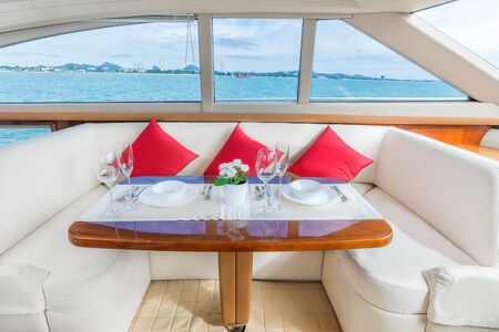 Luxury lunch table setting on a luxury yacht interior comfortable cabin expensive wooden design for...