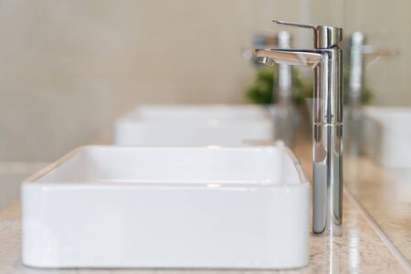 Modern faucet and white ceramic washbasin sink bathroom interior building decoration, concept...