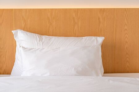 Modern white fabric pillows on the bed interior in bedroom decoration design building contemporary