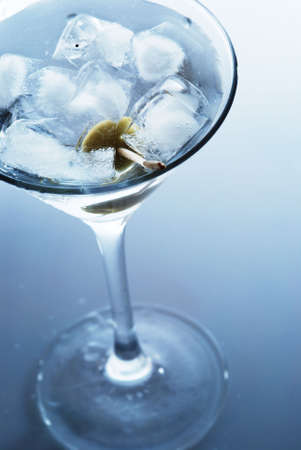 Martini with an olive on a light backgroundの写真素材