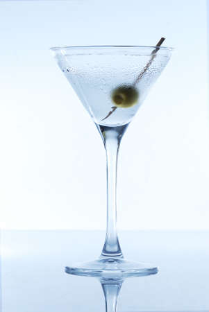 Martini with an olive on a light backgroundの写真素材