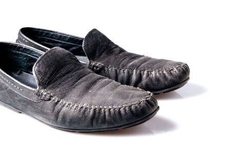 used old shoes over white backgroundの写真素材