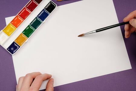 Paintbrushes, paint, and paperの写真素材