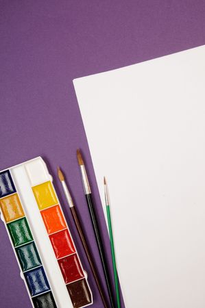 Paintbrushes, paint, and paperの写真素材