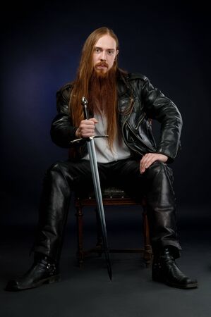 Man in leather clothes tith swordの写真素材