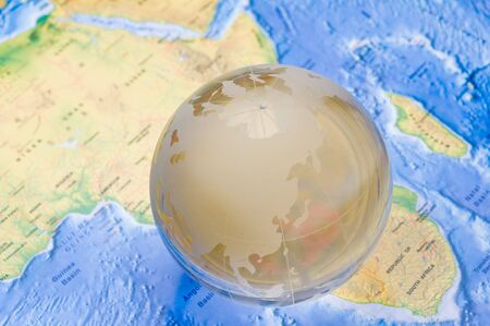 Crystal globe on global map. shallow DOFの写真素材