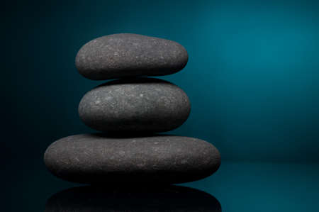 Stack of spa stones over color backgroundの写真素材