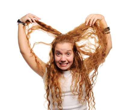 Cute ginger girl holding her long hairの写真素材