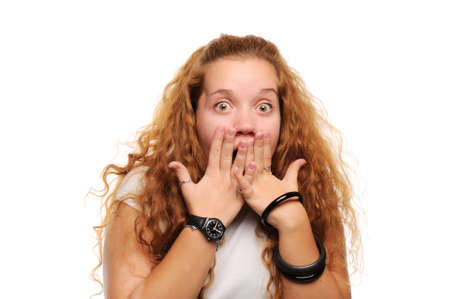 Cute ginger girl surprised, covering her mouth by handsの写真素材