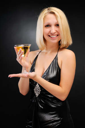 Sexy blonde standing with goblet in both handsの写真素材