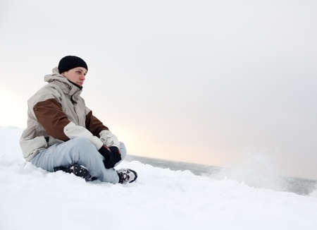 Young man looks a distant scene.の写真素材