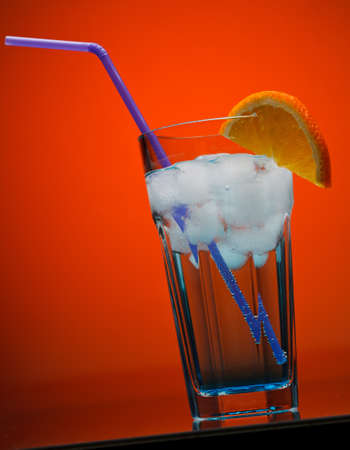 Cocktail over orance backgroundの写真素材