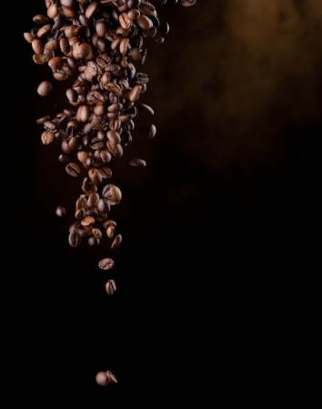Flying coffee beans over darkの写真素材