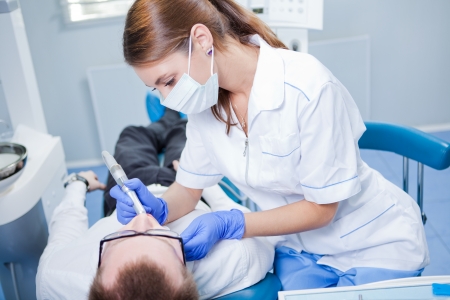 A young female dentist working in her office の写真素材