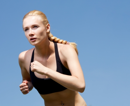 Beautiful young woman runner in natureの写真素材