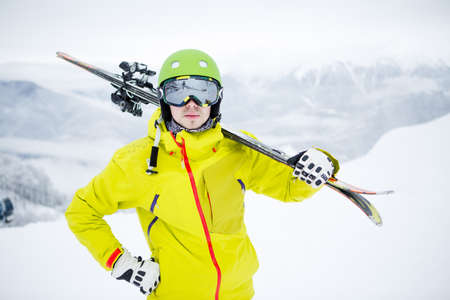 Skier carrying ski boardsの写真素材