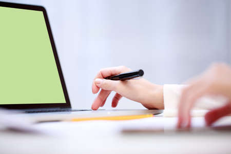 Woman analyzing something at laptop.