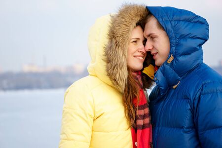 Couple smiling, huggingin winter in a forestの写真素材
