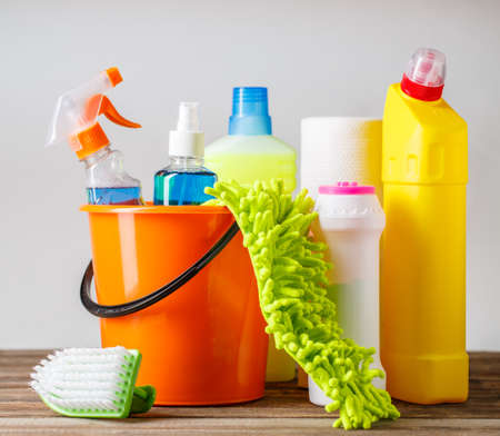 Bucket with cleaning items on light backgroundの写真素材