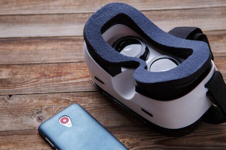 virtual vr glasses goggles headset over wooden background