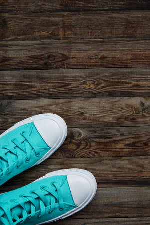 shoes sneakers with laces on empty wooden floorの写真素材