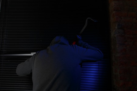 Night thief opens by master key windowの写真素材
