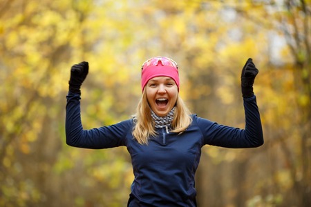 Young happy woman doing exercises in forestの写真素材