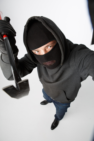 Robber peeps with master key on pure white backgroundの写真素材