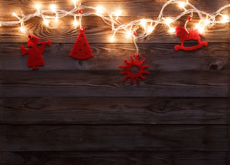 New Year's felt toys with garland on wooden backgroundの写真素材
