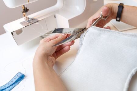 Photo of sewing machine with woman close-up