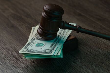 Hammer on dollars at tableの写真素材