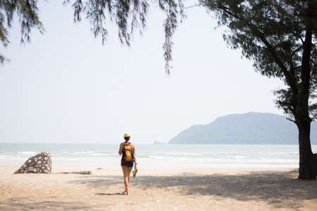 Young brunette walking along beachの写真素材