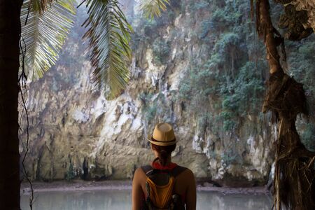 Girl in hat among mountainsの写真素材