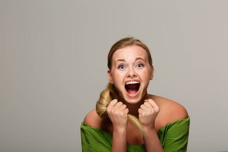 Screaming woman in green dressの写真素材