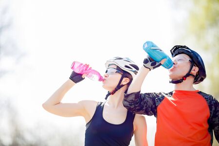Bicyclists drink water from bottleの写真素材