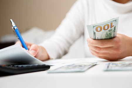 Entrepreneur calculating and reviewing investment planの写真素材