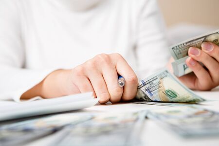 Hands counting money, close up