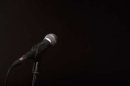 Microphone on empty black backgroundの写真素材