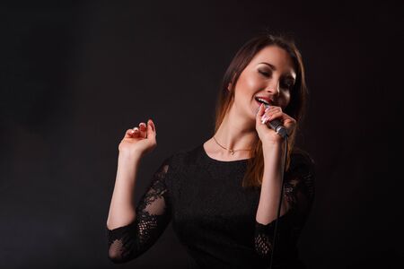 Girl in dress with microphoneの写真素材