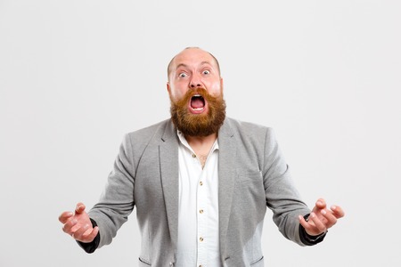 Upset screaming man on empty backgroundの写真素材