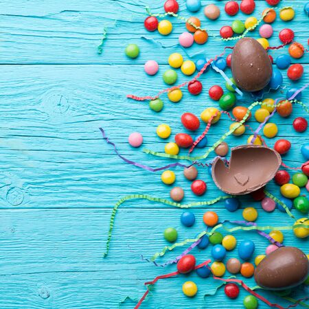 Multicolored sweets, chocolate eggs, ribbons