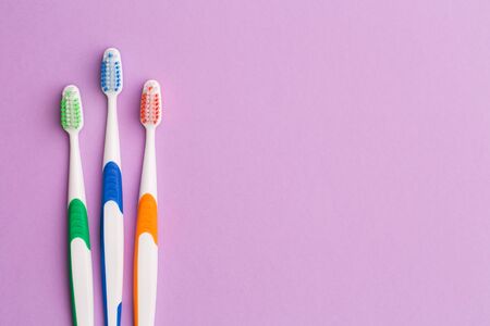 Photo of three colored toothbrushesの写真素材