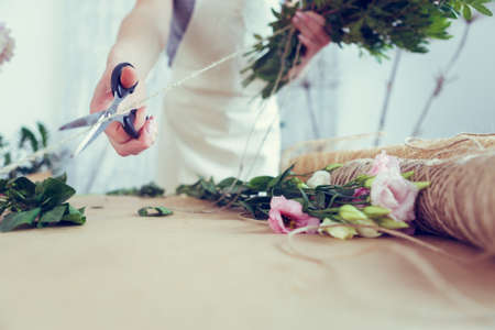 Woman florist makes beautiful bouquetの写真素材