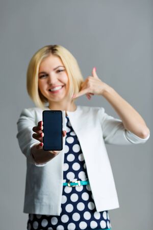 Woman with phone showing shakaの写真素材