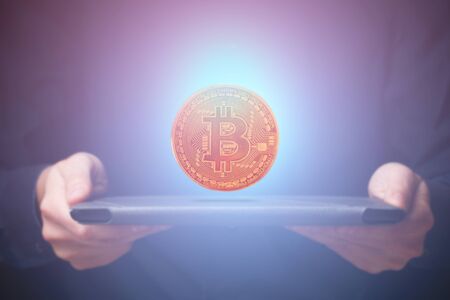 Bitcoin over tabletの写真素材