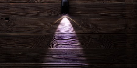 Included flashlight on wooden backgroundの写真素材
