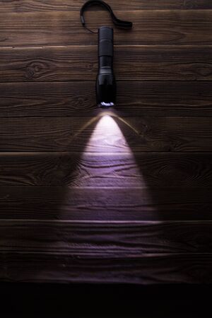 Photo of included flashlight on wooden textureの写真素材