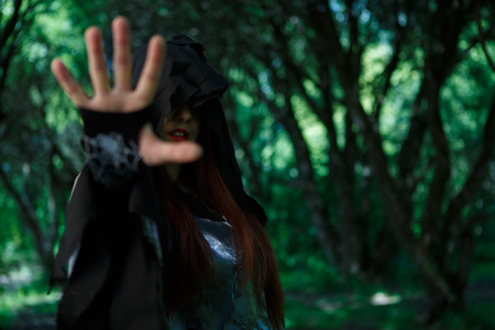 Witch in hood at forestの写真素材